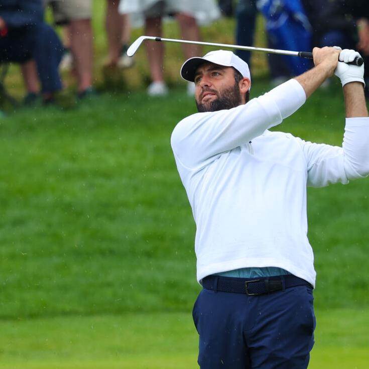 Scottie Scheffler hits an iron on fairway.JPG